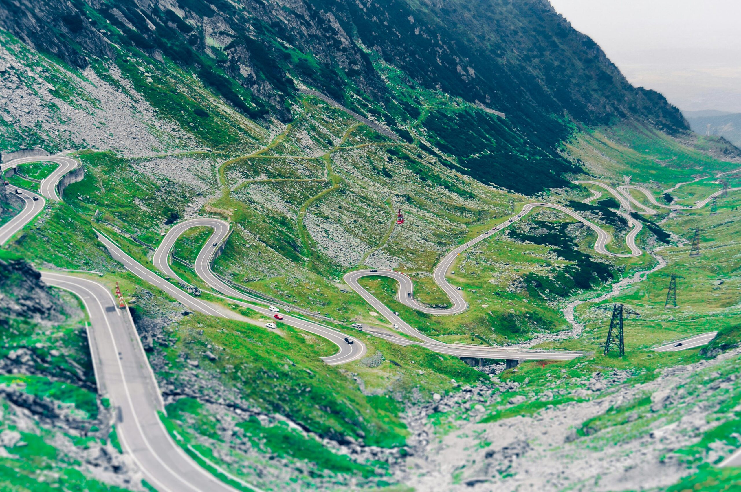 Aerial view of the winding transfagarasan highway in the romanian mountains showcasing lush greenery